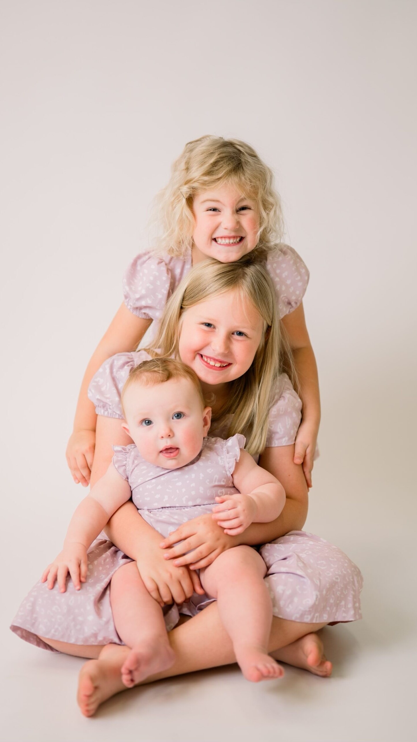 Three sisters posing together during a photo shoot